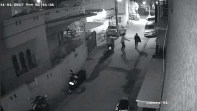 Two men on a scooter assault a woman, attempting to take off her clothes and pushing her to the ground before leaving, in Bengaluru, India, in this still image taken from January 1, 2017 CCTV footage. (Reuters) Two men on a scooter assault a woman, attempting to take off her clothes and pushing her to the ground before leaving, in Bengaluru, India, in this still image taken from January 1, 2017 CCTV footage. (Reuters)