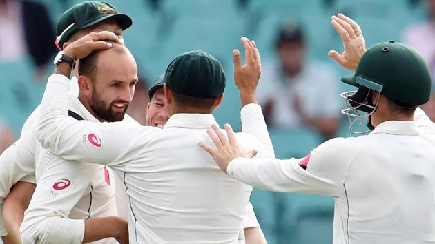 Australia's Nathan Lyon (left) celebrates with teammates after dismissing Pakistan batsman Sharjeel Khan on Day 4 of the third Test match at the SCG in Sydney on Friday. Earlier, David Warner smashed the second fastest 50 in Test history to give Australia a flying start in their chase for runs. The hosts declared at 241-2, setting a victory target of 465 for Pakistan.(AFP)