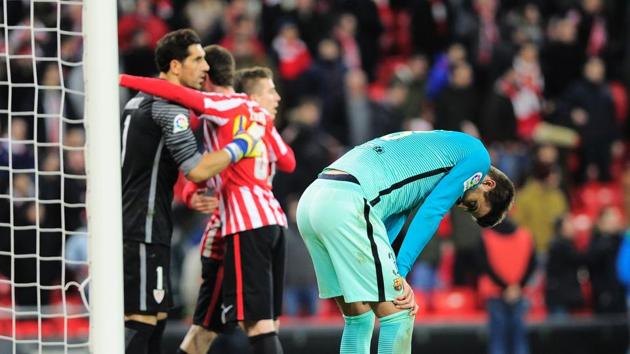 FC Barcelona defender Gerard Pique (right) reactions in dejection as Athletic Bilbao players celebrate after beating the reigning champions in the Spanish Copa del Rey (King's Cup) round of 16 first leg match at the San Mames stadium on Thursday. (AFP) FC Barcelona defender Gerard Pique (right) reactions in dejection as Athletic Bilbao players celebrate after beating the reigning champions in the Spanish Copa del Rey (King's Cup) round of 16 first leg match at the San Mames stadium on Thursday. (AFP)