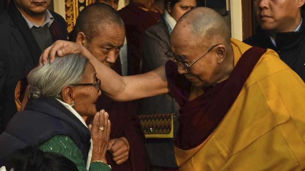 Tibetan spiritual leader the Dalai Lama put his hand on an elderly devotee during the fourth day of Kalachakra in Bodhgay on Thursday. (AP/AP Photo/Manish Bhandari) 