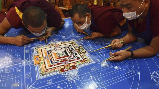 Buddhist monks prepare a Sand Mandala, a spiritual and ritual symbol depicting the Buddhist universe, during the fourth day of Kalachakra in Bodhgaya on Thursday. (AP/AP Photo/Manish Bhandari) 