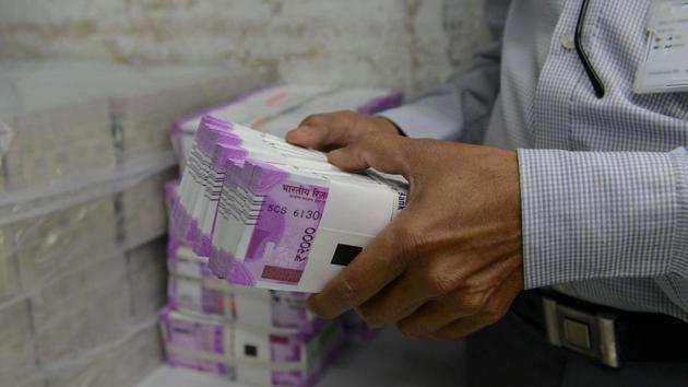 An Indian bank employee checks stacks of new 2000 rupee notes in Ahmedabad on November 11, 2016. Long queues formed outside banks in India as people crowded in to deposit old currency and withdraw new notes after the two largest denomination rupee notes were taken out of circulation. / AFP PHOTO / SAM PANTHAKY (AFP file photo) An Indian bank employee checks stacks of new 2000 rupee notes in Ahmedabad on November 11, 2016. Long queues formed outside banks in India as people crowded in to deposit old currency and withdraw new notes after the two largest denomination rupee notes were taken out of circulation. / AFP PHOTO / SAM PANTHAKY (AFP file photo)