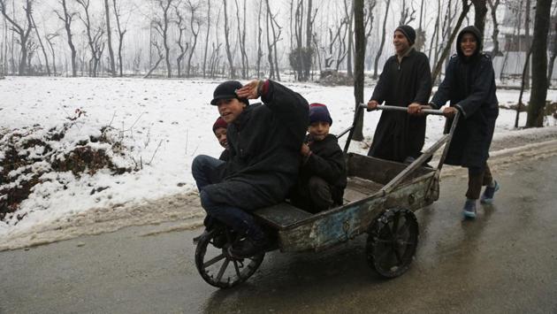 Kashmiri children play with a handcart after fresh snowfall on the outskirts of Srinagar, Indian controlled Kashmir, Wednesday, Jan. 4, 2017. Srinagar experienced the first snowfall of the season Wednesday. (Mukhtar Khan / AP)