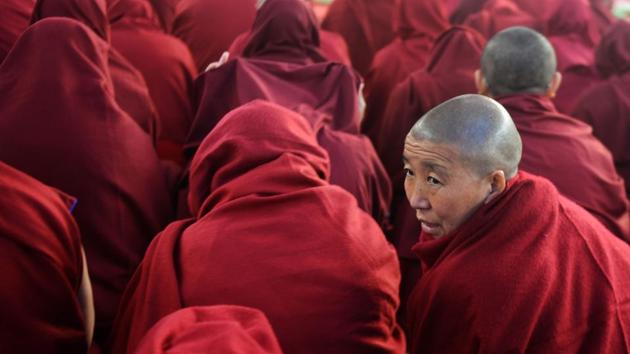 Buddhist monks participate in a special religious teaching prayer attended by the Dalai Lama during the Kalachakra event at Bodhgaya on Friday.  (AFP PHOTO / Dibyangshu SARKAR) 
