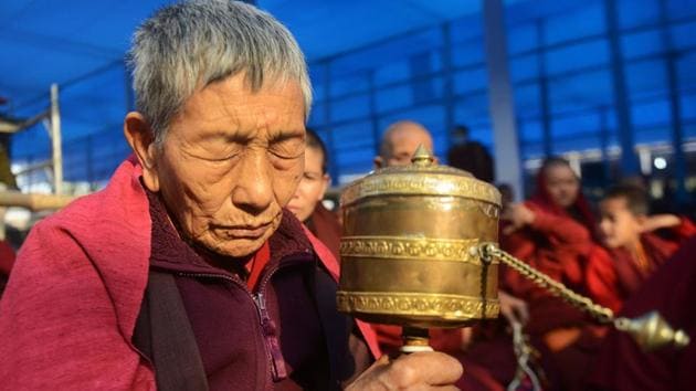Buddhist monks participate in a special religious teaching prayer attended by the Dalai Lama during the Kalachakra event.  (AFP PHOTO / Dibyangshu SARKAR) 
