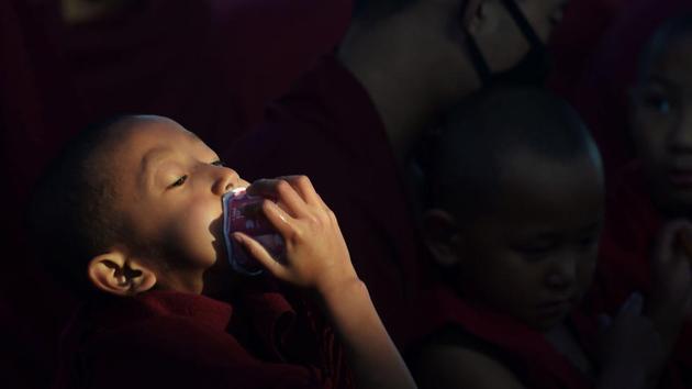 Young Buddhist monks participate in the special religious teaching prayer . (AFP PHOTO / Dibyangshu SARKAR) 