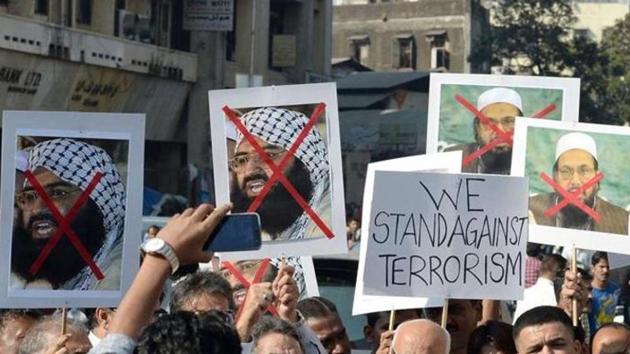 Activists carry photos of JeM chief Maulana Masood Azhar during a protest in Mumbai.(AFP File Photo) Activists carry photos of JeM chief Maulana Masood Azhar during a protest in Mumbai.(AFP File Photo)