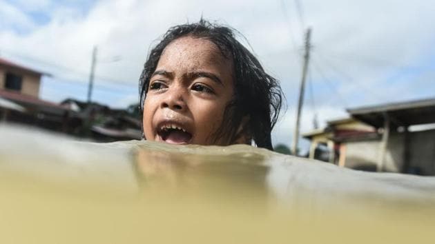 A girl swims in floodwaters in Malaysia's northeastern town of Rantau Panjang, which borders Thailand, on January 5, 2017. (MOHD RASFAN/ AFP) A girl swims in floodwaters in Malaysia's northeastern town of Rantau Panjang, which borders Thailand, on January 5, 2017. (MOHD RASFAN/ AFP)