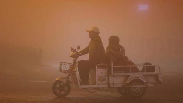 People ride during heavy smog in Lianyungang, Jiangsu province, China. (Reuters) People ride during heavy smog in Lianyungang, Jiangsu province, China. (Reuters)