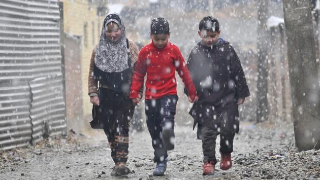 Children walking during the snowfall in Srinagar, India on 05 January 2017. (Waseem Andrabi / HT PHOTO )