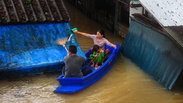 Family navigating floodwaters after heavy rains in Sungai Kolok district in the southern Thai province of Narathiwat. (MADAREE TOHLALA / AFP) Family navigating floodwaters after heavy rains in Sungai Kolok district in the southern Thai province of Narathiwat. (MADAREE TOHLALA / AFP)