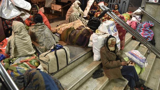After it rained early Saturday morning, people rushed into the AIIMS metro station premises for shelter. (Saumya Khandelwal/HT PHOTO) 