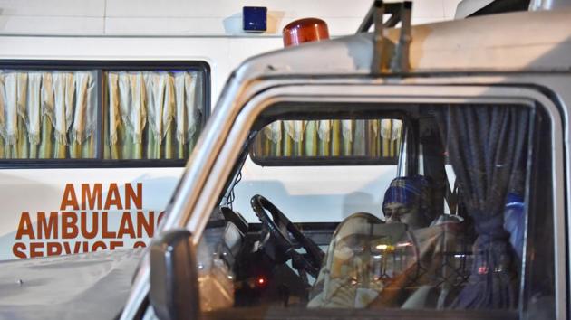 An ambulance driver sleeps inside his vehicle. (Saumya Khandelwal/HT PHOTO) 