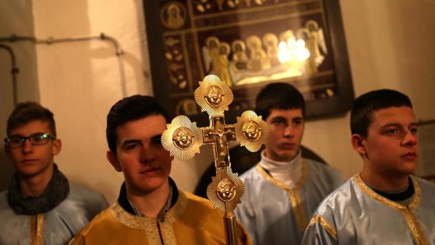 Children pray in the Church of the Holy Prophet Elijah during the eve of Orthodox Christmas in Sokolac, Bosnia and Herzegovina. (Dado Ruvic/REUTERS)