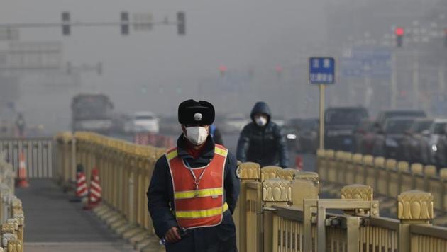 A traffic warden wearing a protection mask walks on a street near Tiananmen Square in Beijing as the capital of China is blanketed by heavy smog on January 4. (AP Photo) A traffic warden wearing a protection mask walks on a street near Tiananmen Square in Beijing as the capital of China is blanketed by heavy smog on January 4. (AP Photo)