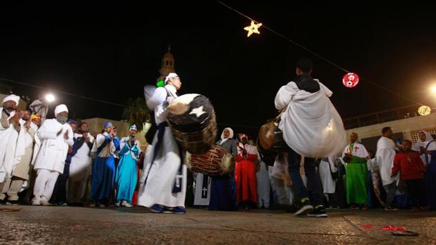 Arytyian Greek Orthodox worshippers celebrate at manager square in front of the Church of the Nativity. (MUSA AL SHAER/AFP)