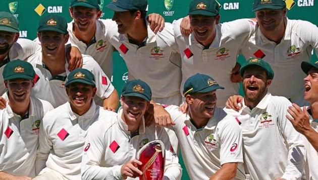 Australia's captain Steve Smith poses with teammates for an official photo after receiving the Australia vs Pakistan Test series trophy at the Sydney Cricket Ground.(Reuters)