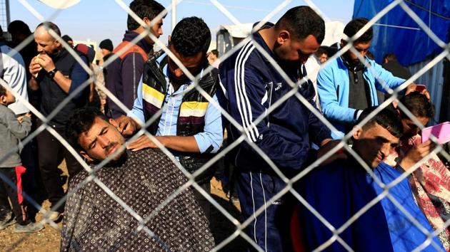 Displaced Iraqi men, who fled Mosul, get haircuts at Khazer camp. (Reuters Photo) Displaced Iraqi men, who fled Mosul, get haircuts at Khazer camp. (Reuters Photo)