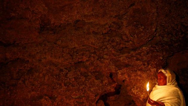 An Ethiopian Orthodox pilgrim holds a candle during the Ethiopian Christmas Eve vigil around Bete Maryam (House of Marry) monolithic church in Lalibela, Ethiopia. Eastern Christians celebrate Christmas on January 7, while those in the West observe it on December 25 due to differences between the Julian and Gregorian calendars. (Tiksa Negeri/Reuters)