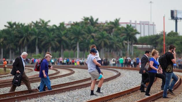 People exit the airport perimeter following a shooting incident at Fort Lauderdale-Hollywood International Airport in Fort Lauderdale, Florida, on Friday. (REUTERS) People exit the airport perimeter following a shooting incident at Fort Lauderdale-Hollywood International Airport in Fort Lauderdale, Florida, on Friday. (REUTERS)