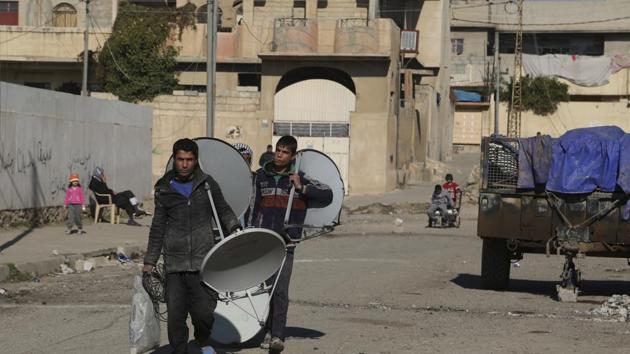 Residents of liberated neighbourhoods carry satellite dishes in the eastern side of Mosul, Iraq. (AP Photo) Residents of liberated neighbourhoods carry satellite dishes in the eastern side of Mosul, Iraq. (AP Photo)