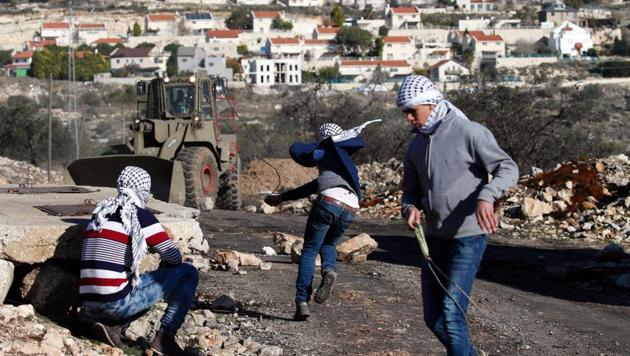 Palestinian protesters hurl stones towards Israeli security forces during clashes following a demonstration against the expropriation of Palestinian land by Israel in the village of Kfar Qaddum, near Nablus, in the occupied West Bank on January 6, 2017. (AFP File) Palestinian protesters hurl stones towards Israeli security forces during clashes following a demonstration against the expropriation of Palestinian land by Israel in the village of Kfar Qaddum, near Nablus, in the occupied West Bank on January 6, 2017. (AFP File)