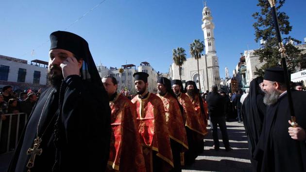 Greek Orthodox clergy parade in Manger Square outside the Church of the Nativity in the biblical West Bank town of Bethlehem. (Hazem Bader/AFP)