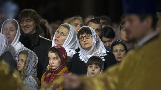 Believers listen as Russian Orthodox Patriarch Kirill serves the Christmas Mass in the Christ the Savior Cathedralin. (Alexander Zemlianichenko/AP)