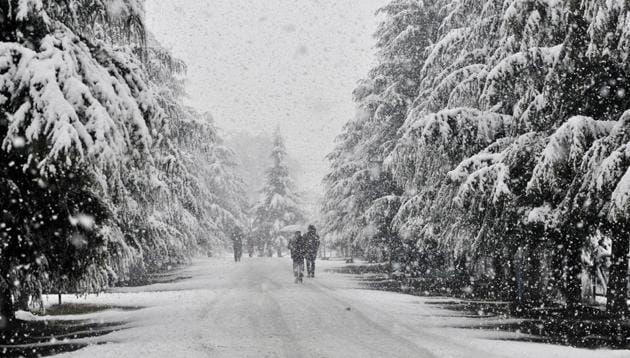 Kashmiri men walk on a snow covered road during a snowfall on January 6, 2017 in Srinagar, India. (HT Photo) Kashmiri men walk on a snow covered road during a snowfall on January 6, 2017 in Srinagar, India. (HT Photo)