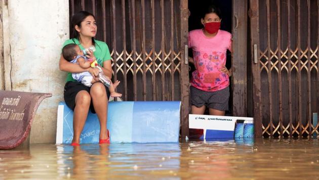 Women look out from a flooded house in the southern Thai village of Chauat on January 7. (AFP Photo) Women look out from a flooded house in the southern Thai village of Chauat on January 7. (AFP Photo)