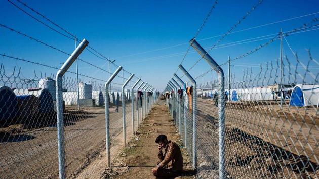 A man talks on a phone at the Khazer refugee camp near the Kurdish checkpoint of Aski kalak, 40km West of Arbil. (AFP Photo) A man talks on a phone at the Khazer refugee camp near the Kurdish checkpoint of Aski kalak, 40km West of Arbil. (AFP Photo)