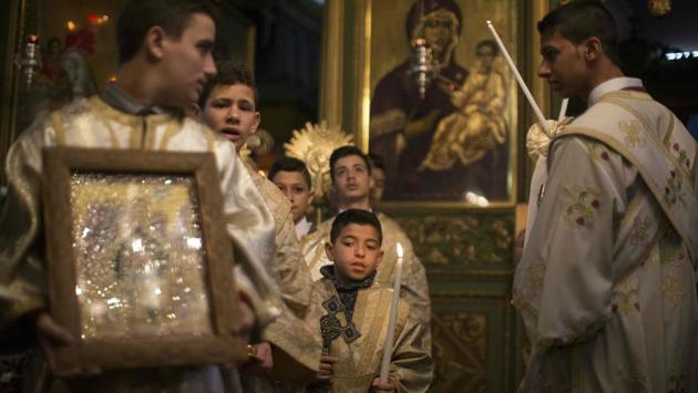 Palestinian Orthodox Christian altar boys attend a Christmas mass at the Saint Porphyrios Greek Orthodox church in Gaza City. (Mahmud Hams/AFP)