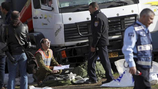 Israeli police investigates the scene of an attack in Jerusalem. A Palestinian rammed his truck into a group of Israeli soldiers in Jerusalem, killing four people and wounding 15 others. (AP Photo) Israeli police investigates the scene of an attack in Jerusalem. A Palestinian rammed his truck into a group of Israeli soldiers in Jerusalem, killing four people and wounding 15 others. (AP Photo)