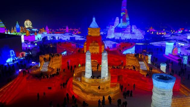 In this December 31 photo, visitors take a tour of a castle-like structure made from blocks of ice at the Harbin International Ice and Snow festival held in Harbin in northeastern's China's Heilongjiang province. The city of Harbin in China's frigid northeast is in its final stages of preparation for one of the world's largest ice and snow festivals, an annual event that last year drew more than a million visitors. (AP)