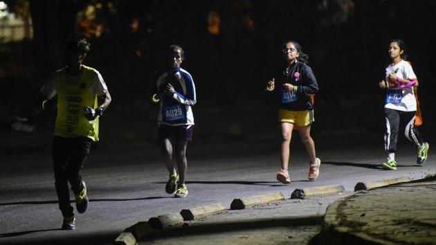 Women participate in a 7km night run to spread awareness on women’s safety in Mumbai on Saturday.  (Kunal Patil / HT Photo) 