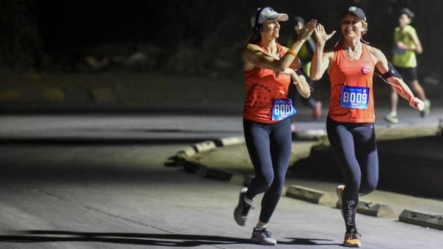 Women participate in a 7km night run to spread awareness on women’s safety in Mumbai on Saturday.  (Kunal Patil / HT Photo) 