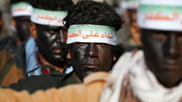 Newly recruited Houthi fighters rehearse for a parade before heading to the frontline to fight against government forces, in Sanaa, Yemen, on January 3. The headband reads: "We are tough on infidels." (REUTERS)
