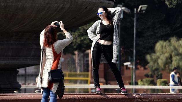 Foreign tourists click photos and enjoying the weather at Vijay chowk, in New Delhi January 04. (Sonu Mehta/HT PHOTO)