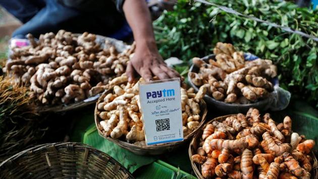 An advertisement board displaying a QR code for Paytm, a digital wallet company, is seen placed amidst vegetables at a roadside vendor's stall in Mumbai on November 19, 2016.(REUTERS)