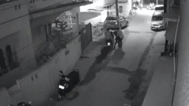 A screengrab from a CCTV footage shows two men on a scooter assaulting a woman in Bengaluru. (Reuters file)