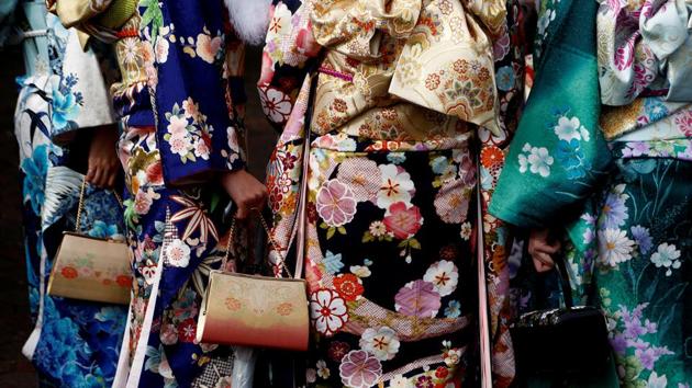 Women in kimonos display their bags. (REUTERS)