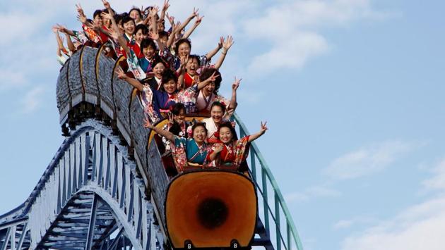 The young women ride a roller-coaster during their Coming of Age Day celebration ceremony at an amusement park in Tokyo. (REUTERS)
