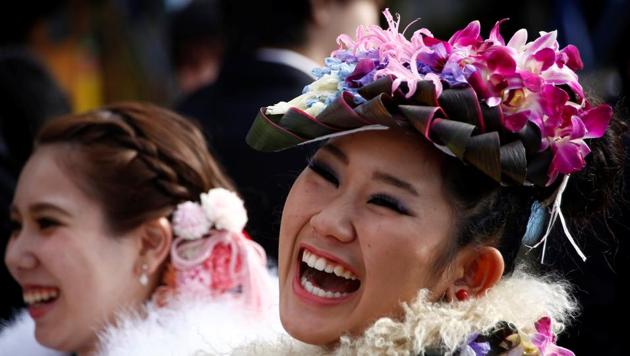 Japanese women wearing kimonos smile after their Coming of Age Day celebration ceremony at an amusement park in Tokyo. (REUTERS)