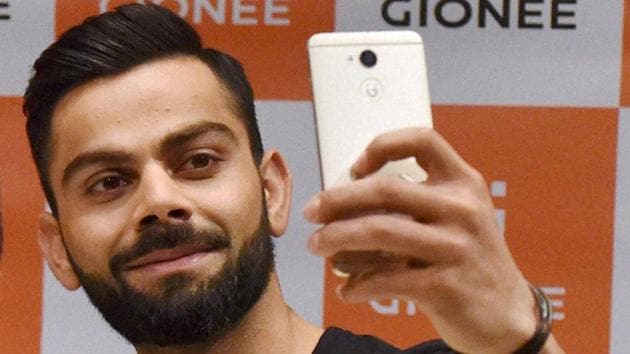 Virat Kohli takes a selfie as a Gionee brand ambassador in Mumbai on Monday. (PTI)