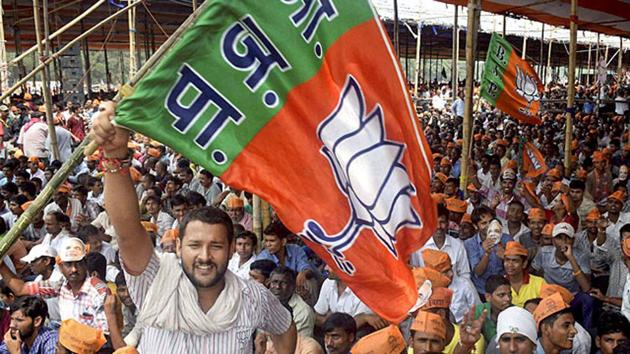 A BJP supporter waves a party flag at NDA's Parivartan Rally in Bhagalpur (PTI Photo) A BJP supporter waves a party flag at NDA's Parivartan Rally in Bhagalpur (PTI Photo)