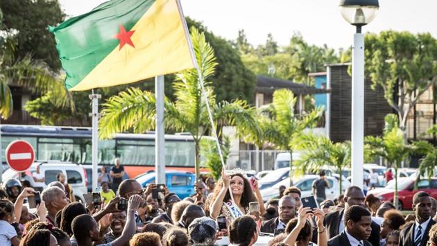 Miss Guyana 2016 and newly elected Miss France 2017 Alicia Aylies, waves a Guiana flag to the crowd as she parades in a car on January 9. (jody amiet / AFP) Miss Guyana 2016 and newly elected Miss France 2017 Alicia Aylies, waves a Guiana flag to the crowd as she parades in a car on January 9. (jody amiet / AFP)