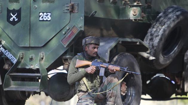 A soldier takes position outside a General Reserve Engineer Force camp in Akhnoor sector, near Jammu, where three civilians were killed in a militant attack.(AP Photo)