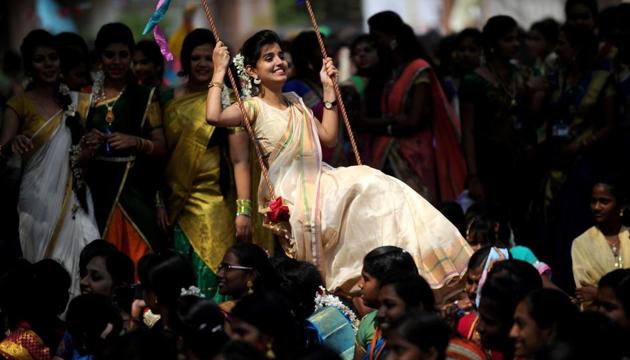 A student plays on a swing during celebrations of the Tamil harvest festival Pongal at a college in Chennai on Wednesday. (AFP photo)