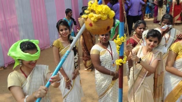 A student tries to break a mud pot during Pongal celebrations in Chennai. (AFP)