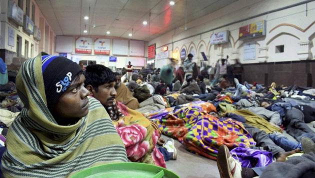Passengers wait for trains delayed due to foggy weather. (PTI)
